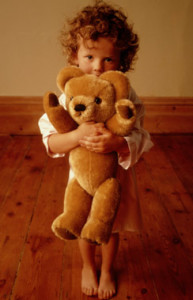 Girl (3-5) holding teddy bear, portrait